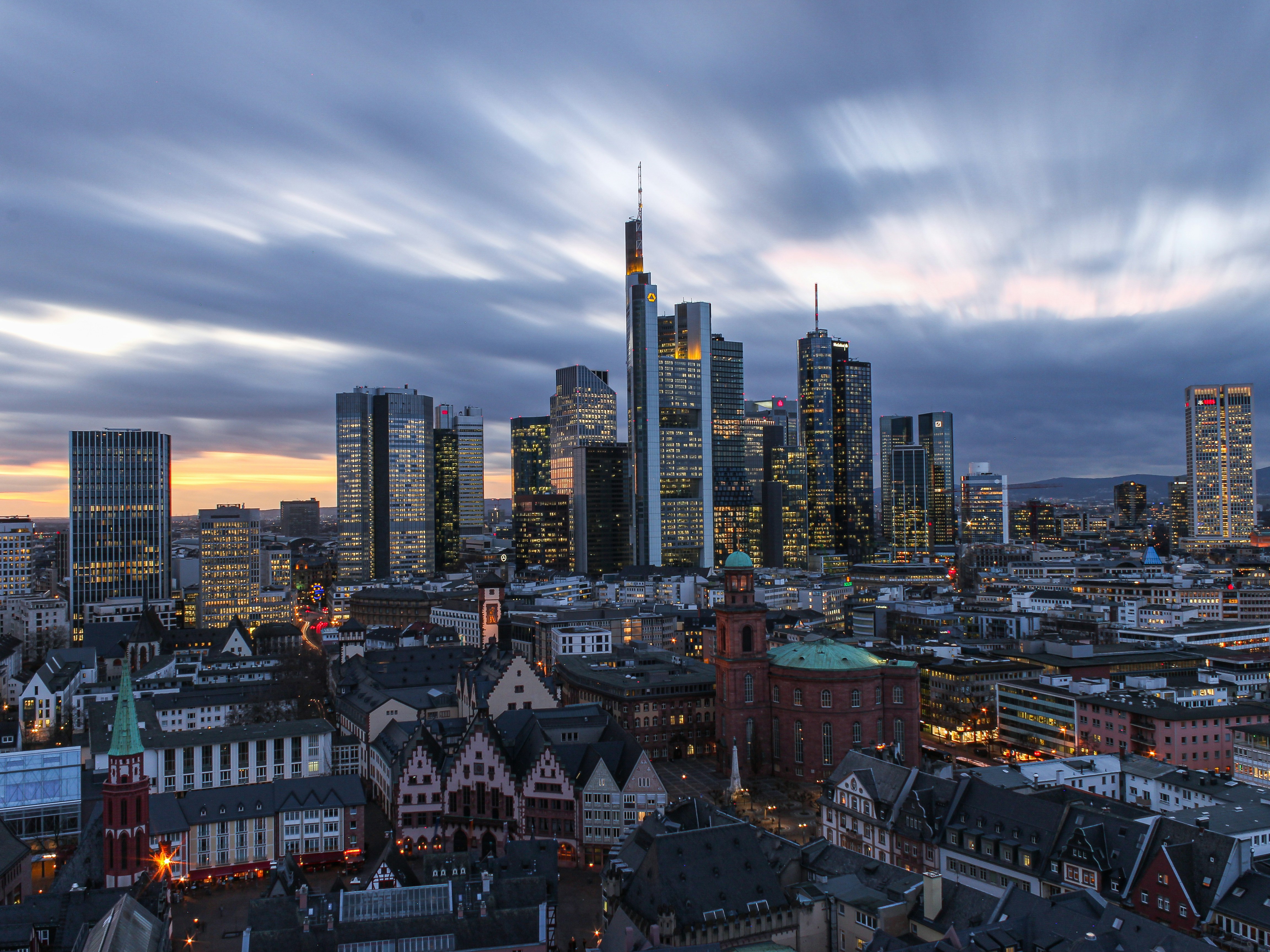 city skyline under white clouds during daytime